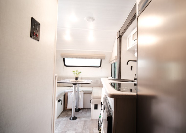 Dinette booth with a pedestal table that converts to a bed